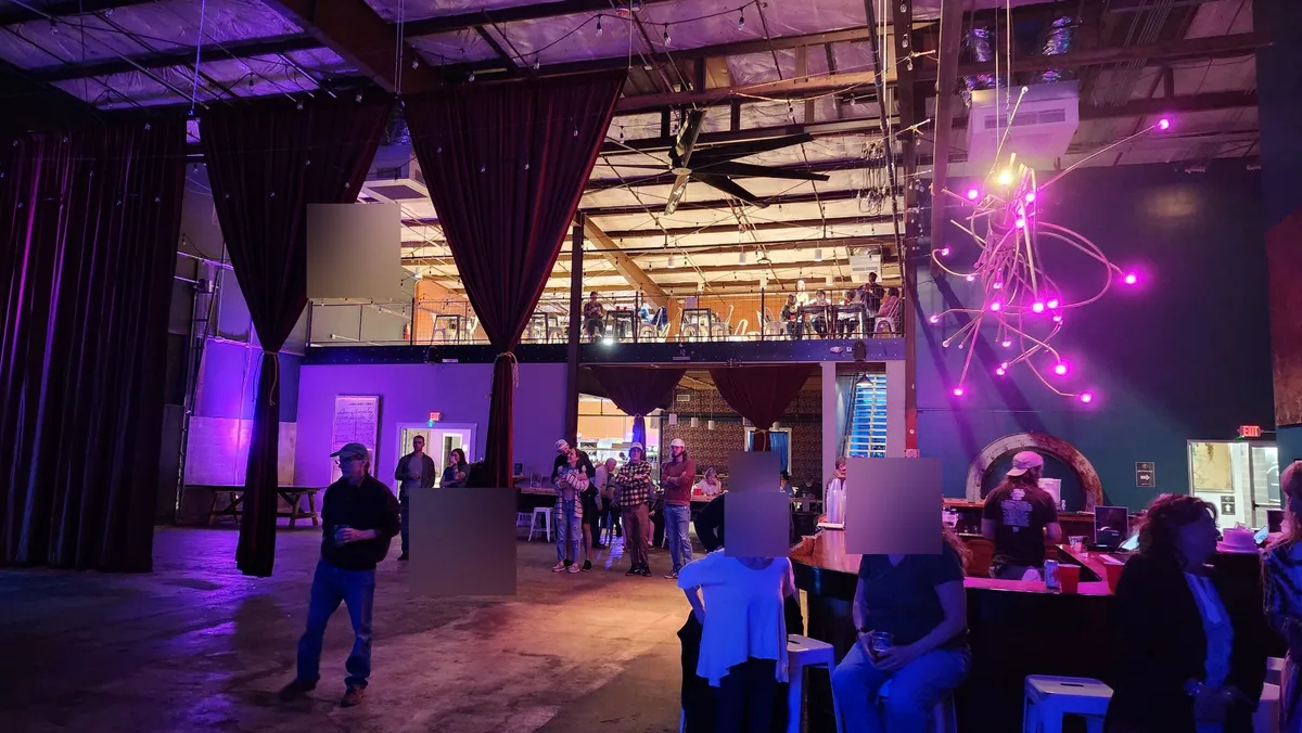 The bar during a show, with guests and seating on the mezzanine above