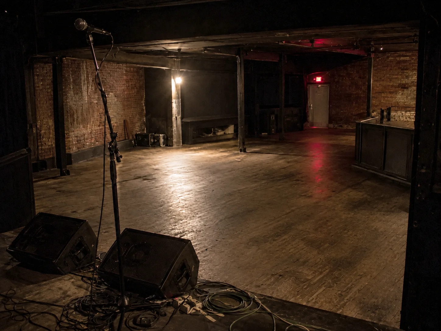 An empty venue floor seen from the stage before doors